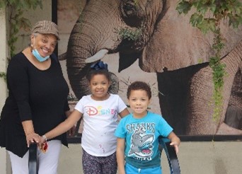 Christina C with grandchildren Moriyah and Cayden at an event