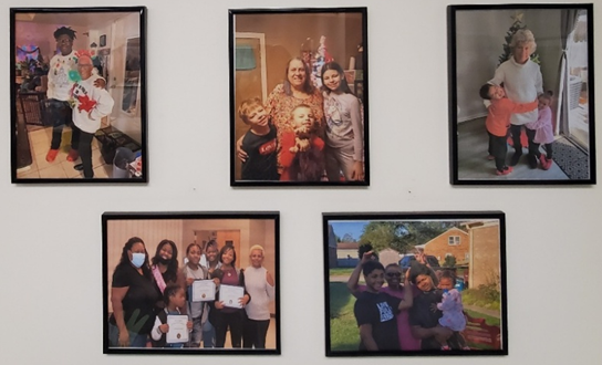 A photo of a wall with five photographs of diverse kinship/adoptive/foster families