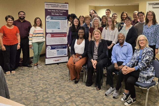 A diverse group of Network staff, partners, and subject matter experts pose for a group photo