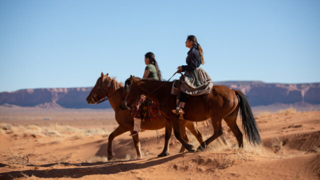 Native American sisters riding horses in Monument Valley, Arizona